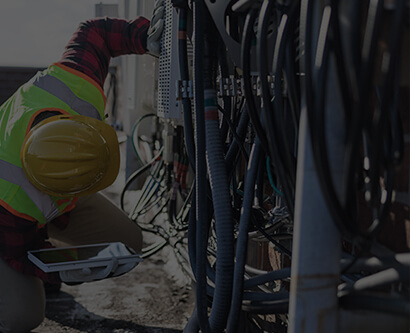 A man is checking the work of power electronics.