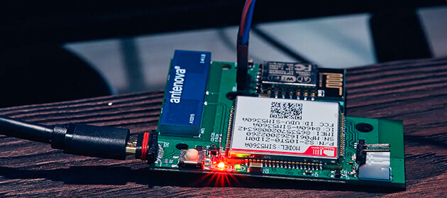 A PCB and a computer screen with a code snippet 