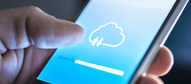 A man is using the cloud on his smartphone to download data.