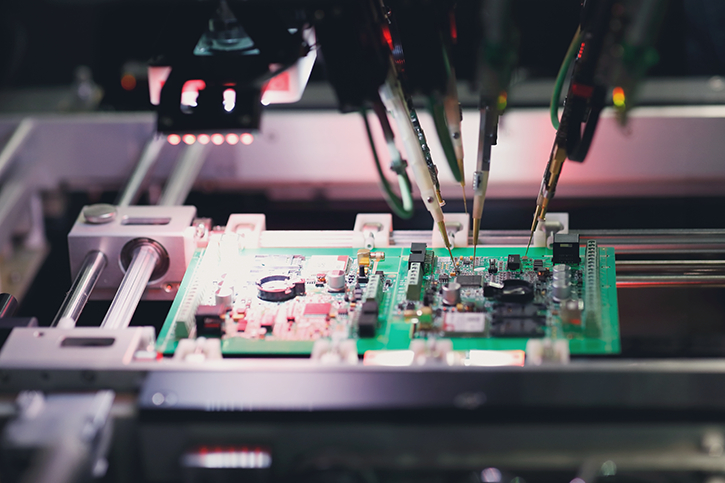 A flying probe testing machine checking a circuit board