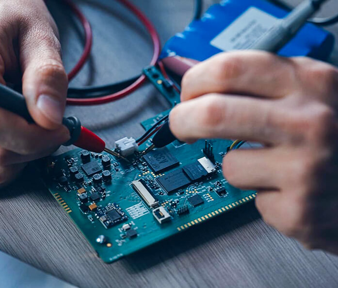An embedded developer is working on a printed circuit board.