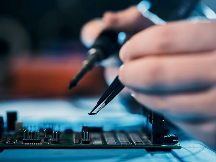 An engineer is mounting a chip on a PCB