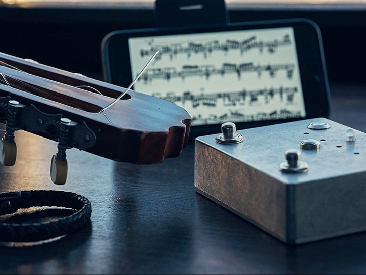 A musical pedal that can turn music sheets on mobile devices via Bluetooth connection.