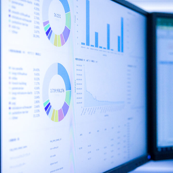 Two monitors with graphs and diagrams.