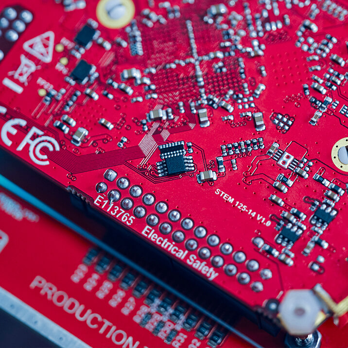A red PCB with an FPGA. 