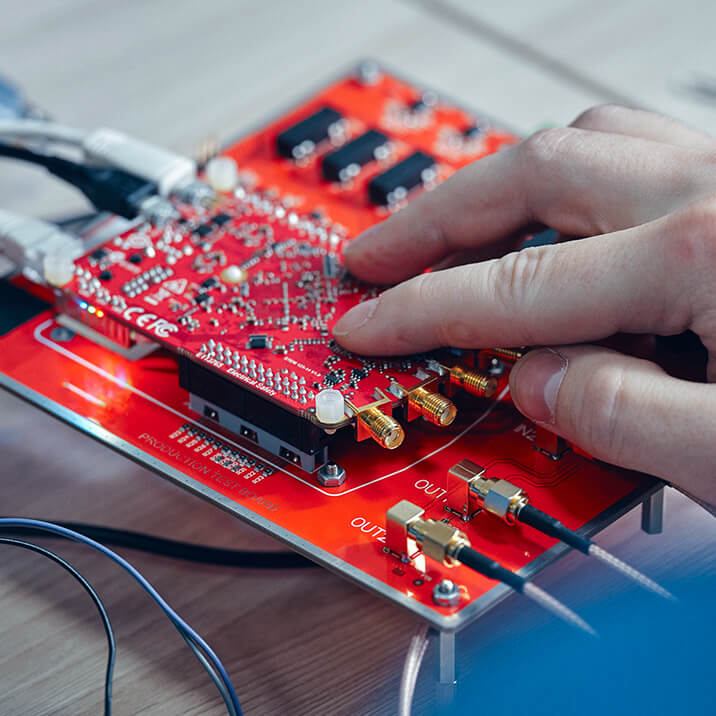 An engineer is working on an FPGA printed circuit board.