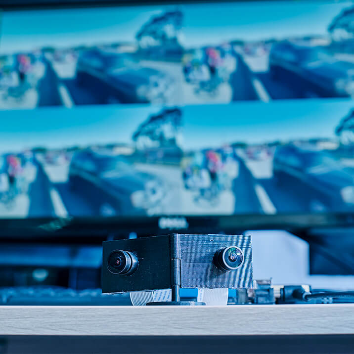 An embedded device with cameras, created by Integra Sources, in front of a monitor.