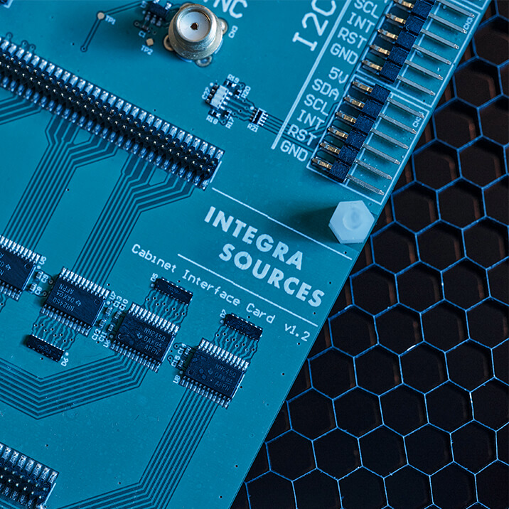 A paper sheet with a PCB schematic and a printed circuit board lying on it.